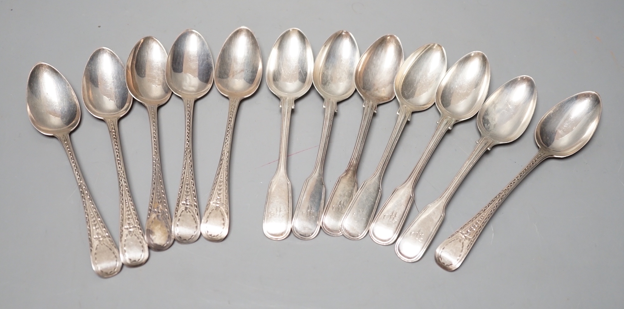 A set of six Victorian silver fiddle and thread pattern teaspoons, London, 1853 and a matched set of six Victorian silver bright cut engraved Old English pattern teaspoons, 9oz.